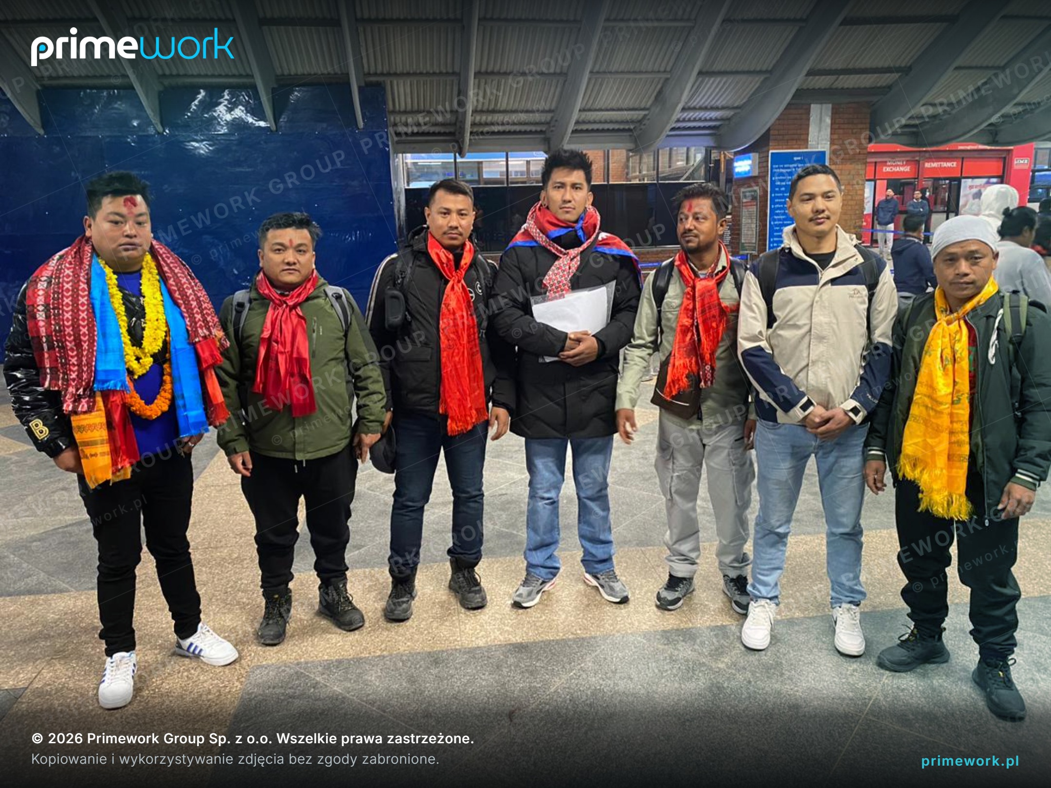 A group of Nepali workers in traditional scarves before departure for Bulgaria
